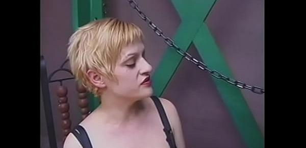  Mature blonde in leather lingerie puts out cigarettes on the body of her muscle slave